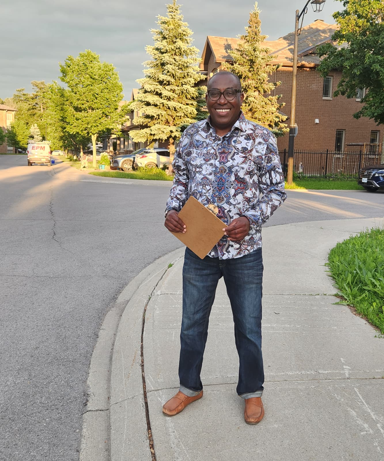 Jules Ruhinda holding a clipboard while canvassing in Barrhaven East