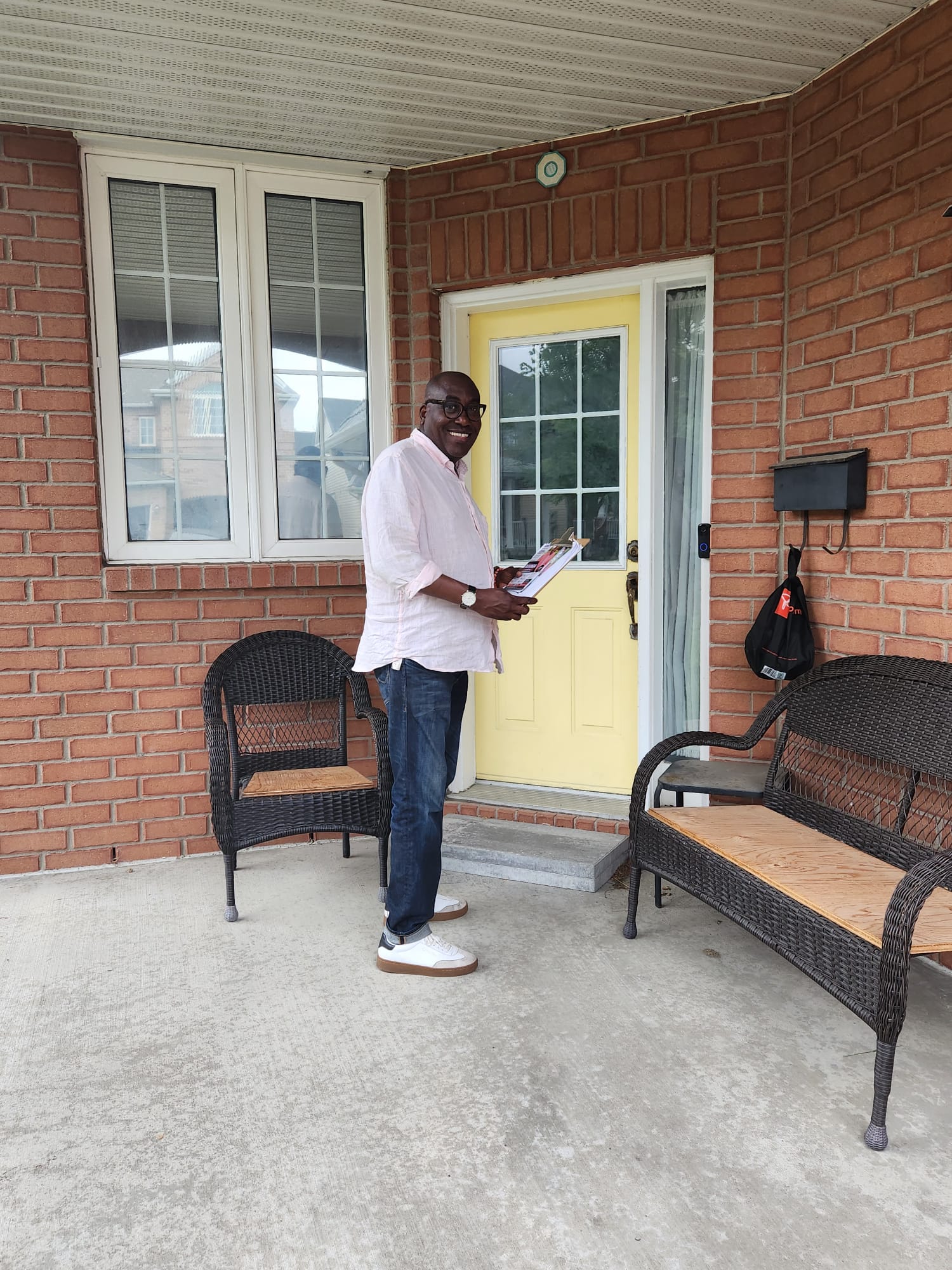 Jules Ruhinda canvassing at a resident's door in Barrhaven East