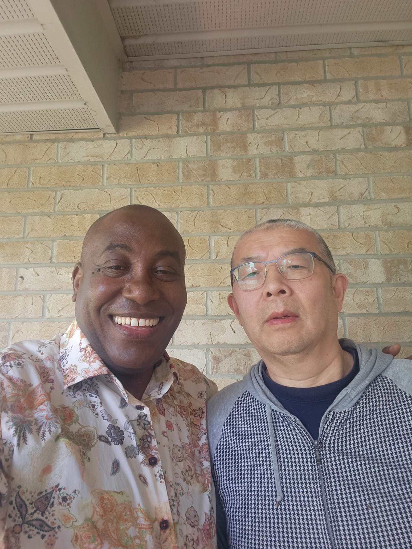 Jules Ruhinda with a community member
